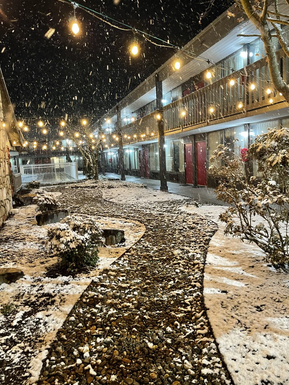 a snow falling on a walkway