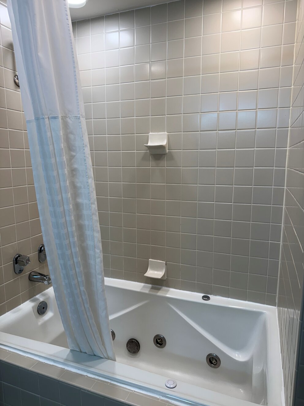 a white shower curtain in a bathroom